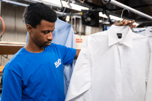 man looking at dry cleaned dress shirt