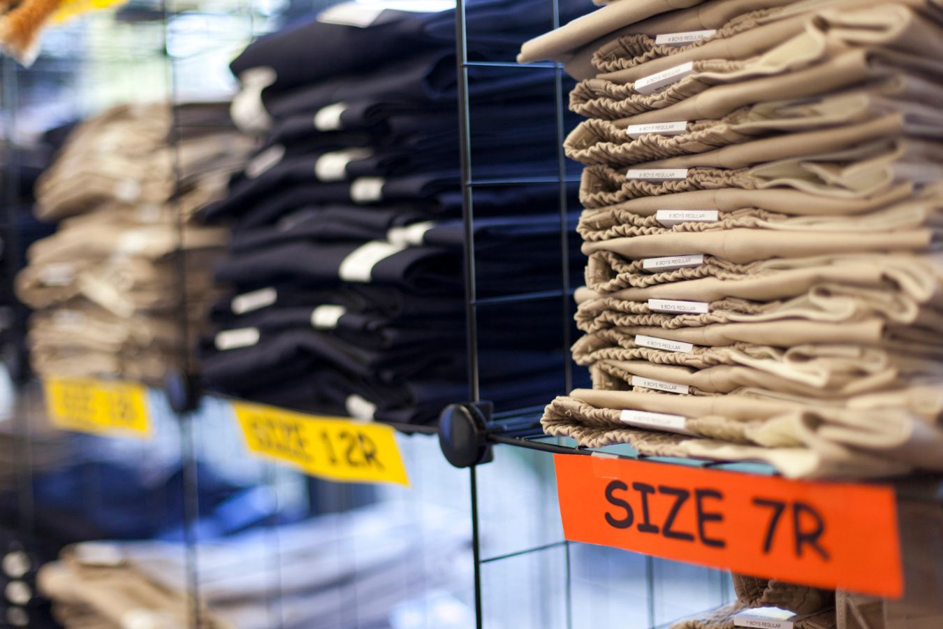 school uniforms in stacks sorted by size