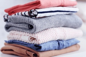 stack of clean folded clothes after going through wash and fold service