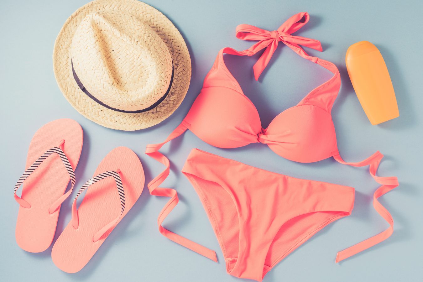 washed swimsuit laying out to dry with beach supplies