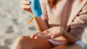 woman applying sunscreen before staining clothes