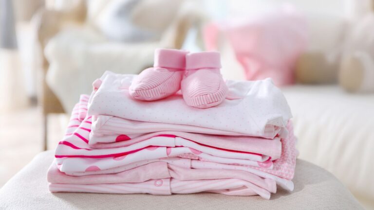 freshly washed and folded baby clothes