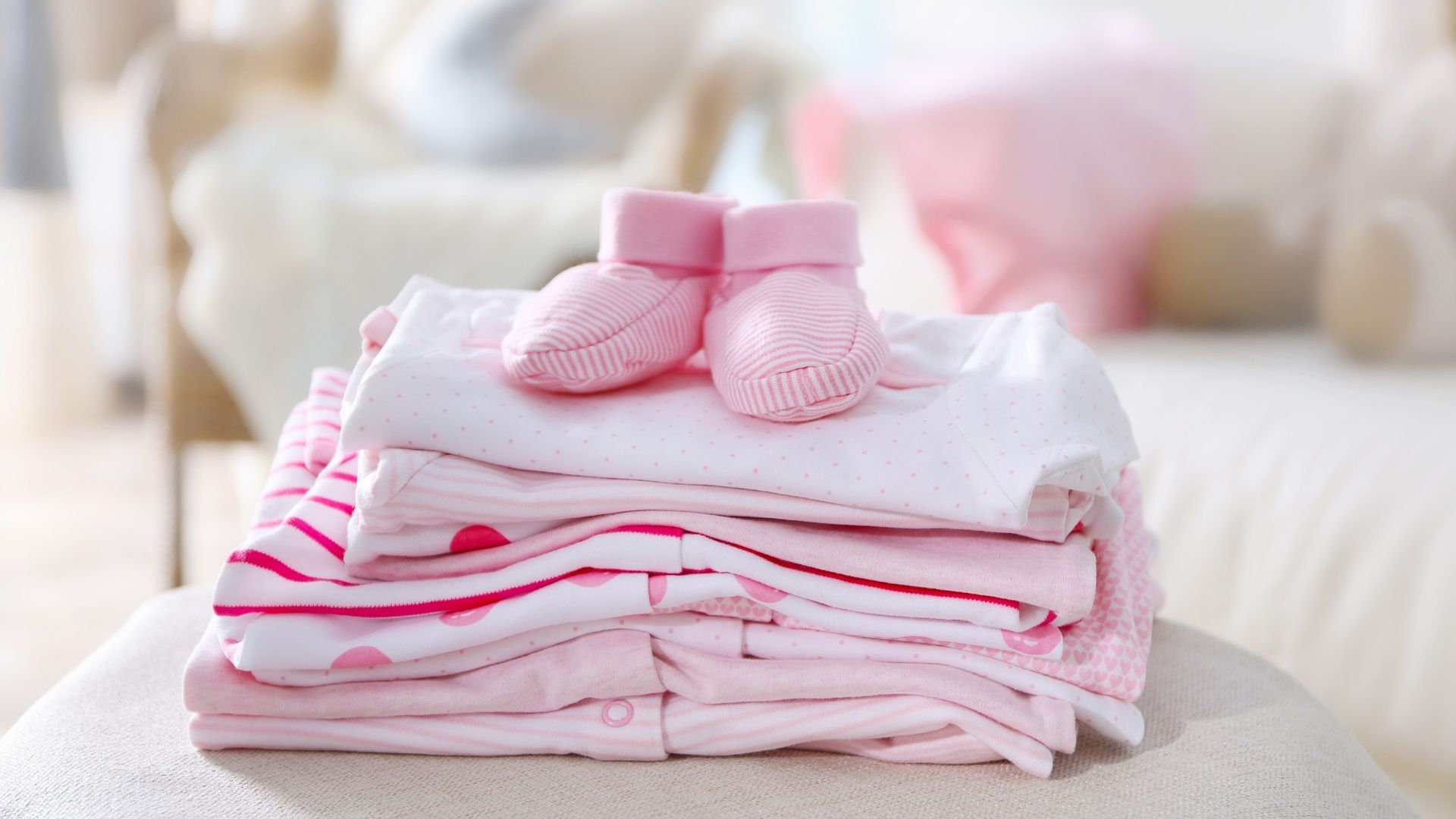 freshly washed and folded baby clothes